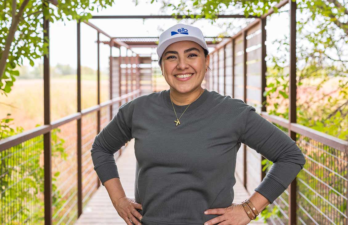A person wearing a white SLB hat