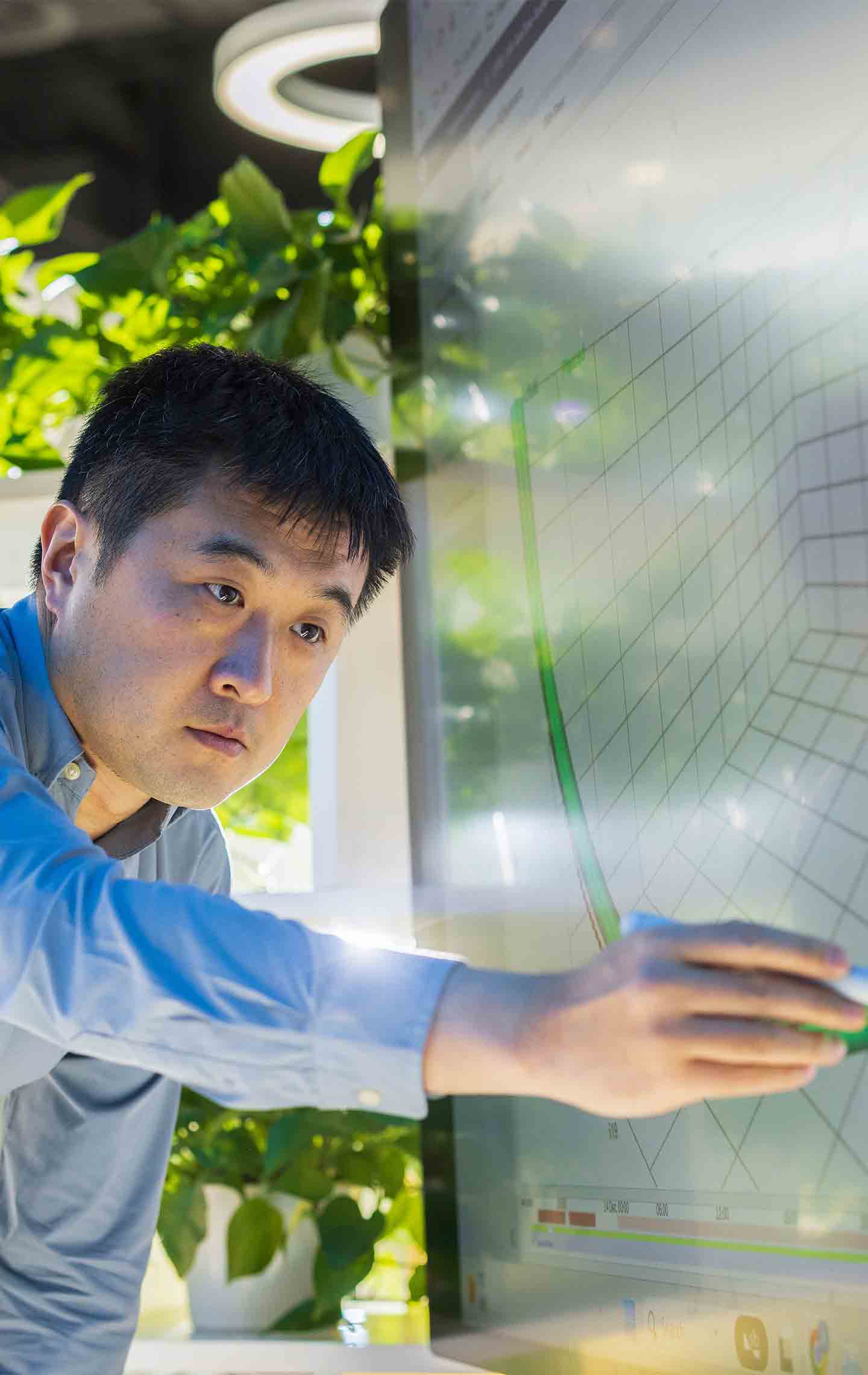 A person writing on an office whiteboard