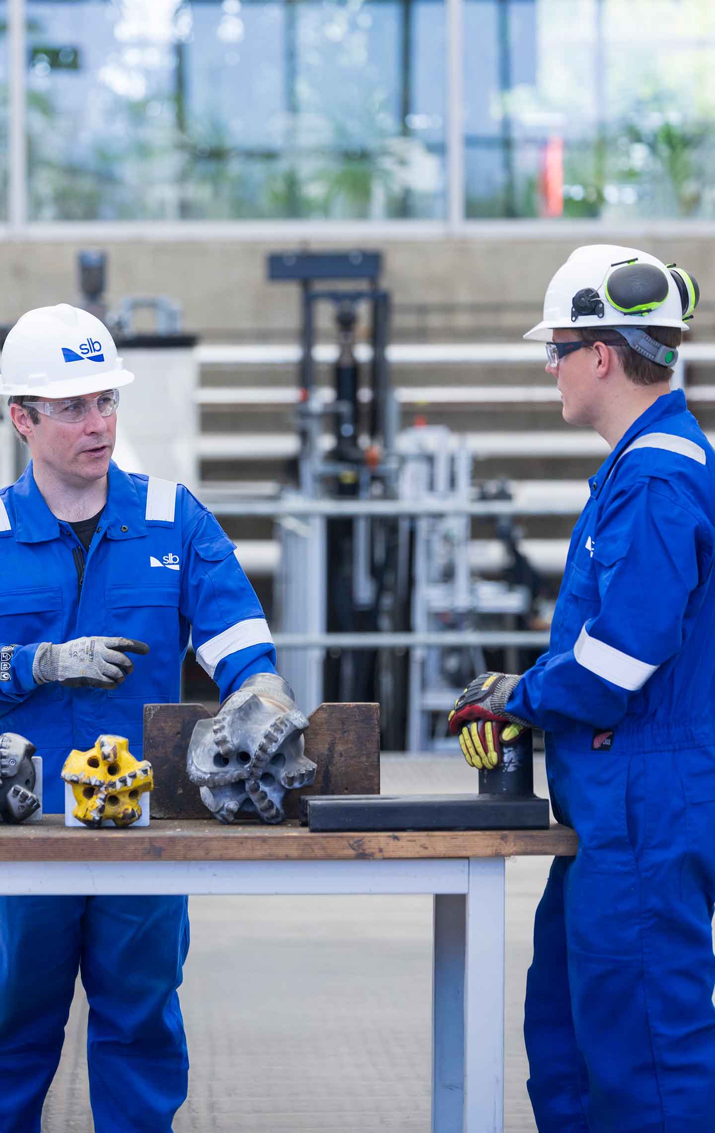 An SLB employee sitting outside wearing a blue SLB t-shirt