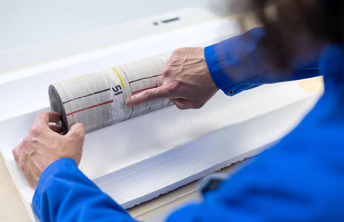 A SLB engineer inspecting  a core sample