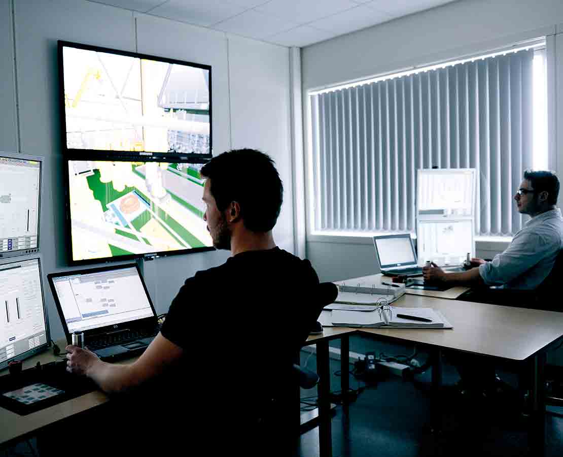 Worker in monitoring center viewing data.