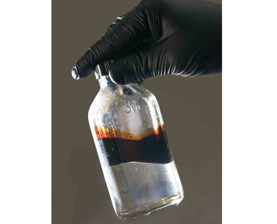 Bottle test shows effective separation of oil from produced water by WT-11033.
