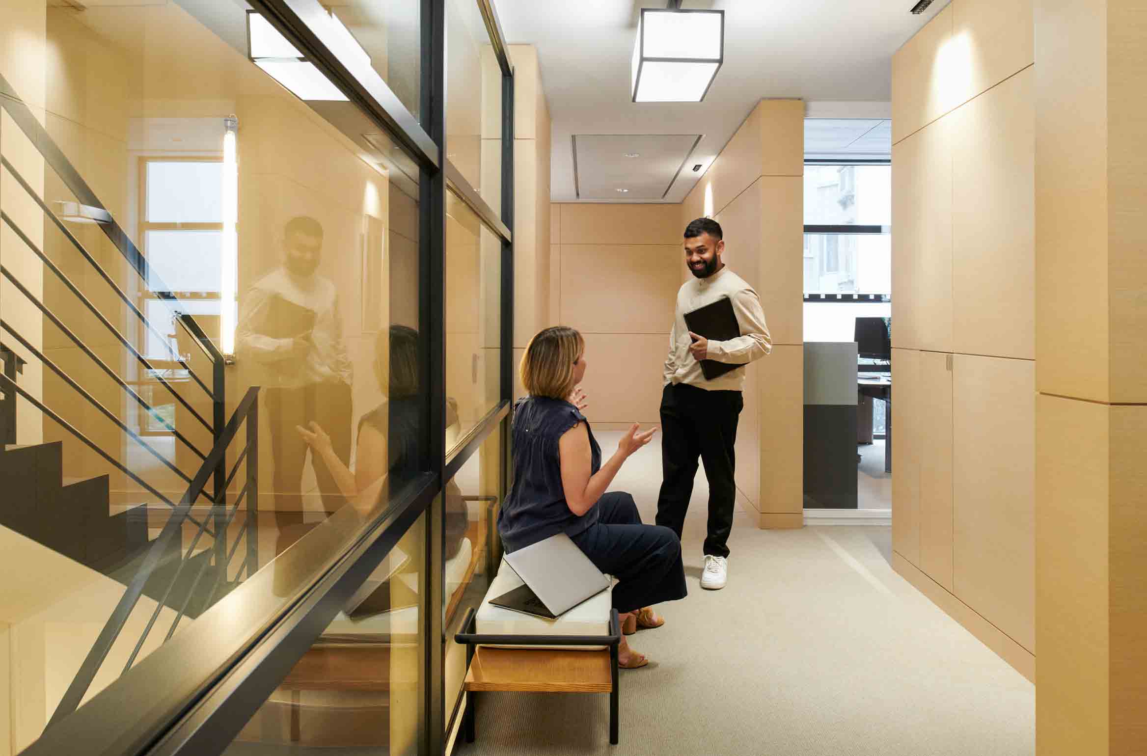 Photo of people collaborating in an office hallway