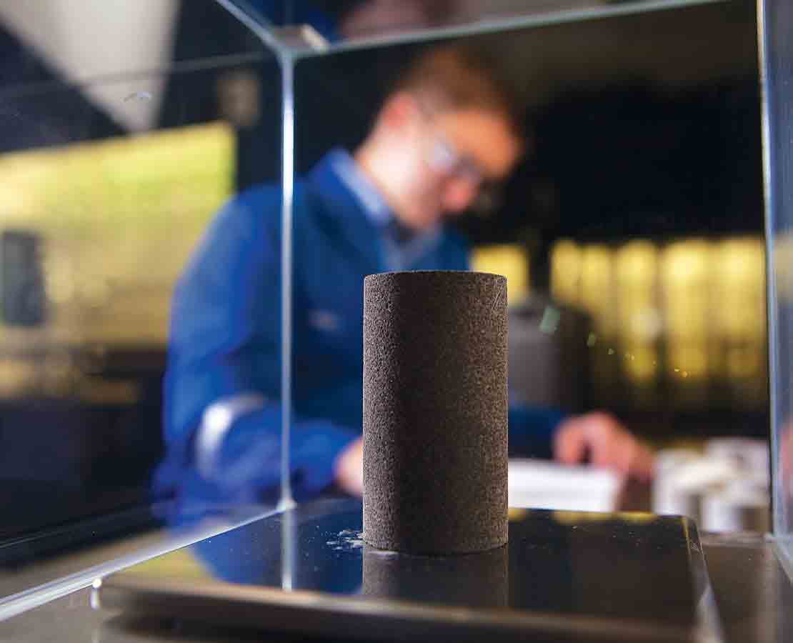 Schlumberger worker in the lab performing core analysis as part of the geomechanics services.