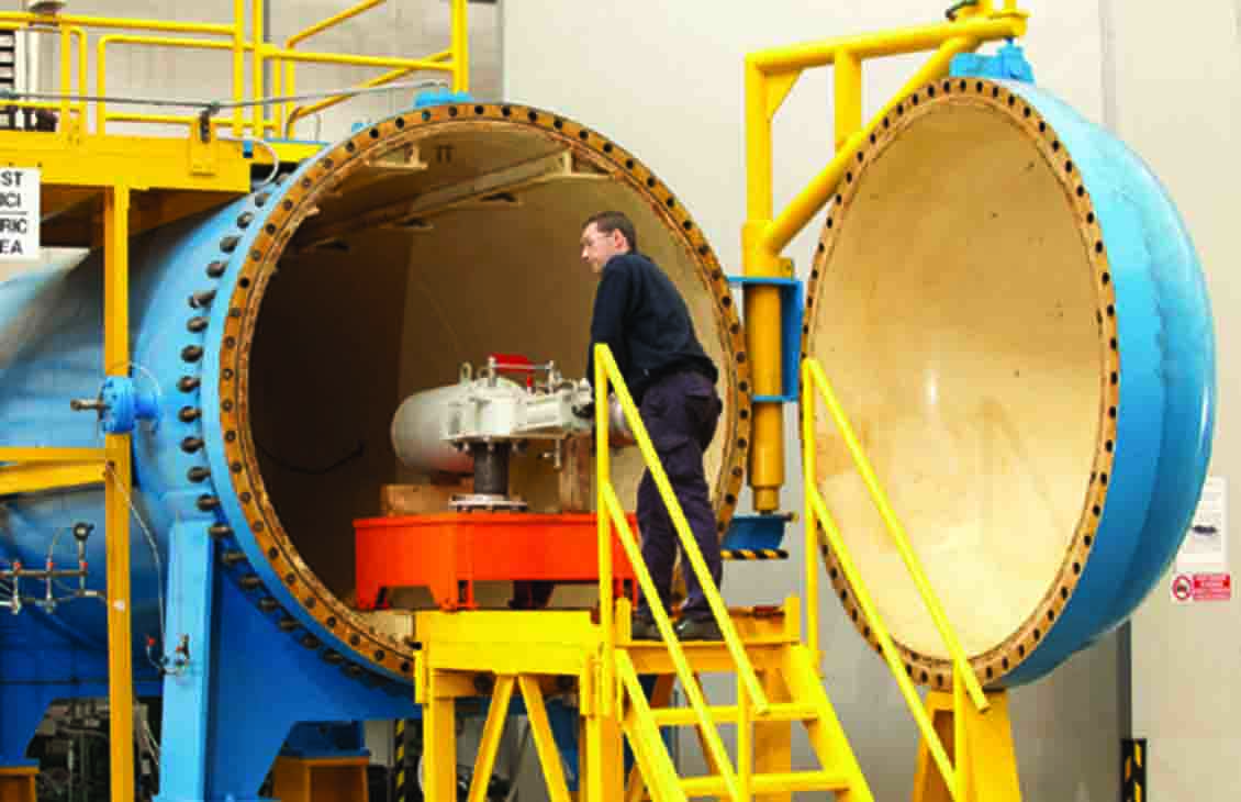 Cameron employee loading an actuator in a warehouse.