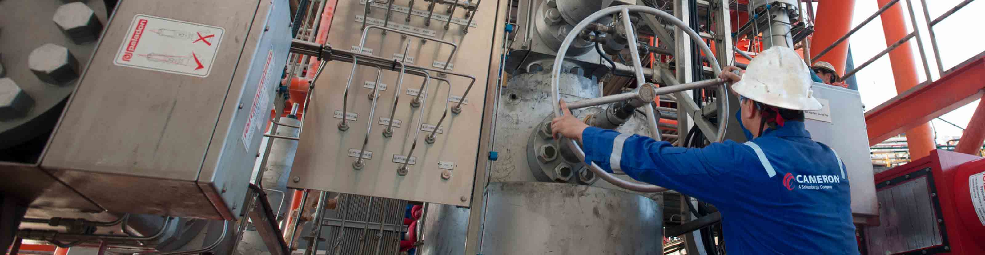 A man operating a valve.